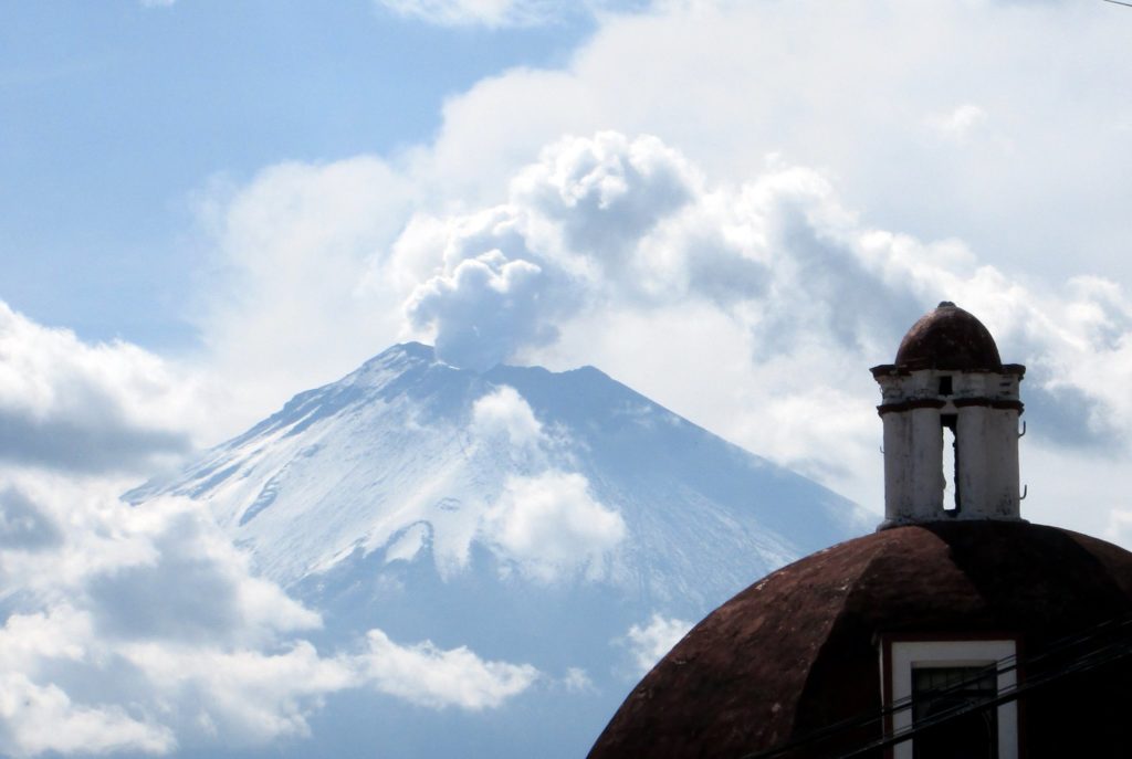 View of mountain past building