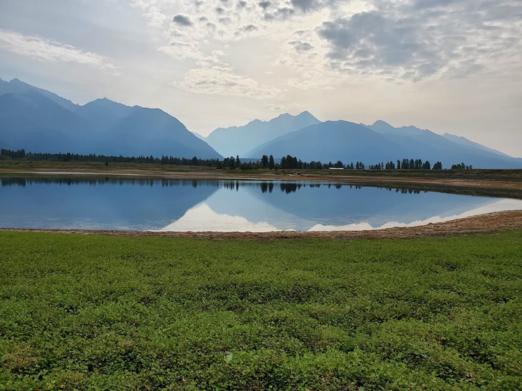 View of lake with hills behind it