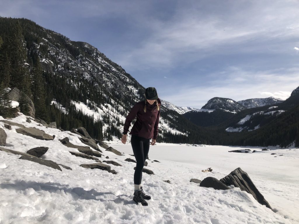 AmeriCorps member posing on snowy hillside