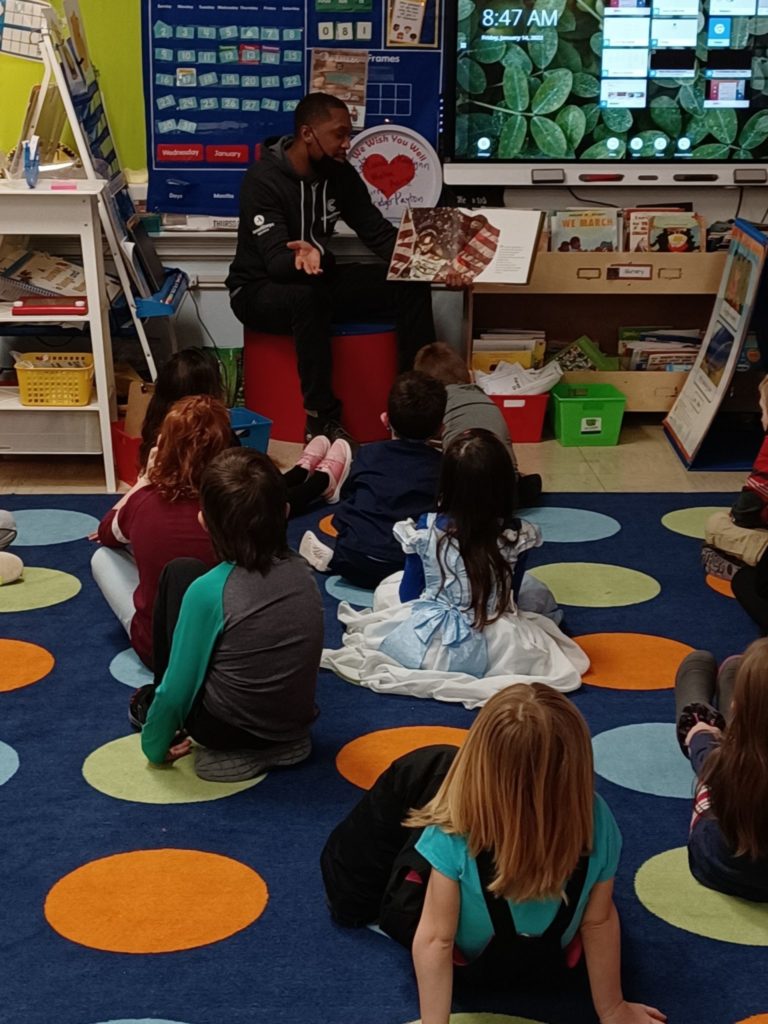 AmeriCorps member reading to kids on MLK day