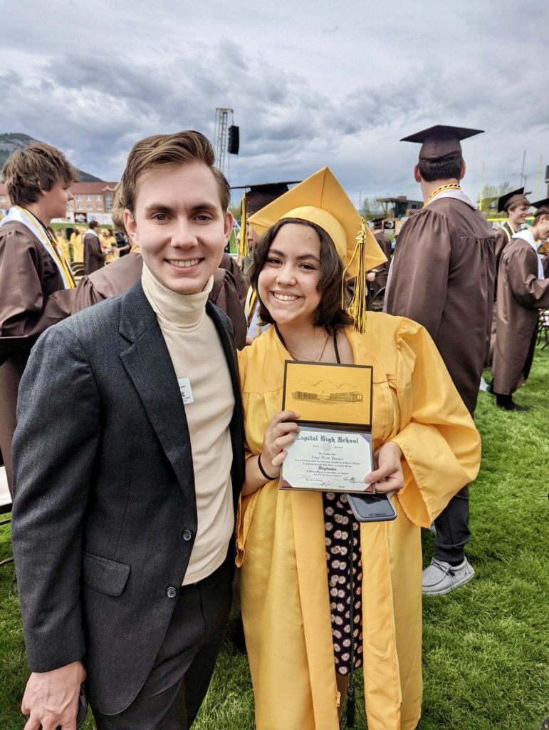 AmeriCorps Member posing proudly with high school graduate